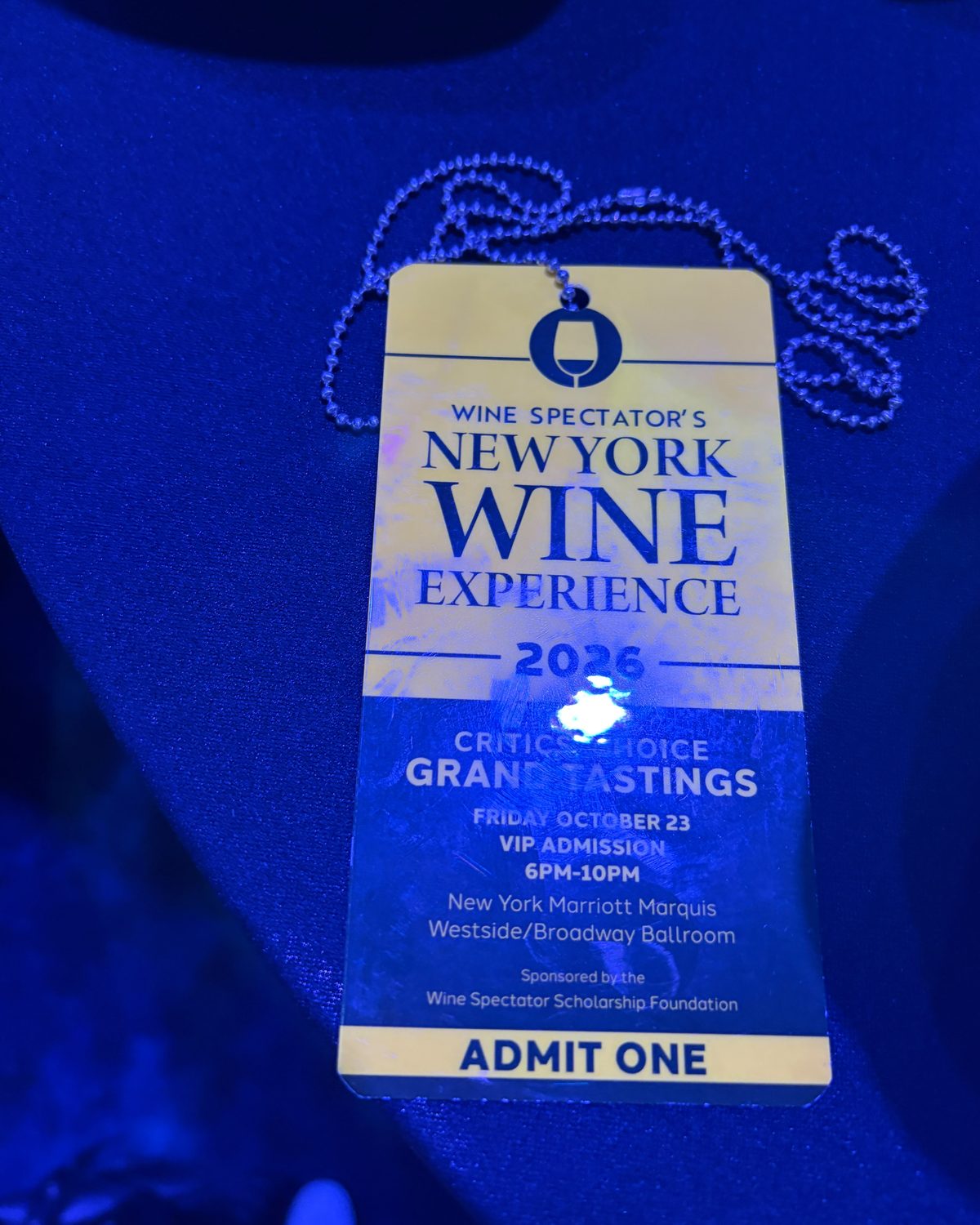 A VIP admission badge for the Friday Critics' Choice Grand Tasting, lit blue